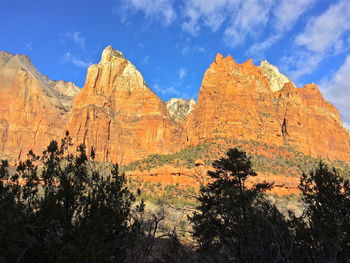 Low angle view of rocky mountains against blue sky at zion national park