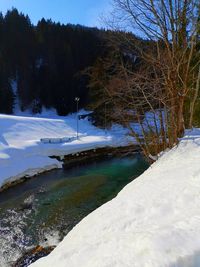 Scenic view of frozen lake against sky during winter