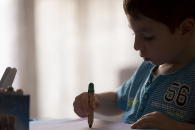 Close-up of boy drawing on paper