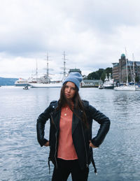 Young woman standing on boat against sky