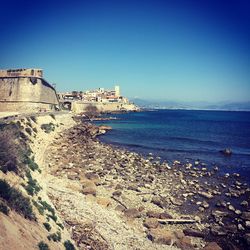 Scenic view of sea against clear blue sky