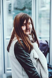 Young woman looking at window