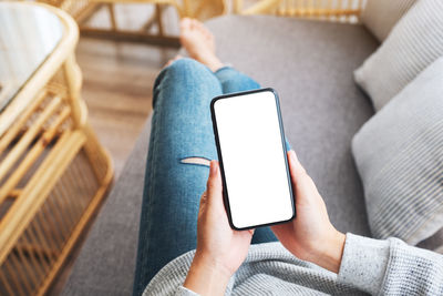 Midsection of woman using mobile phone