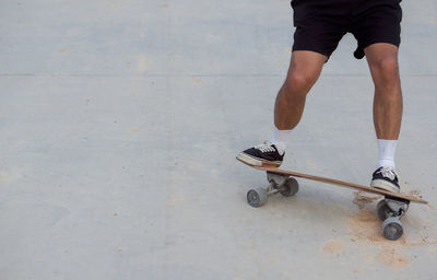 Low section of man skateboarding on skateboard