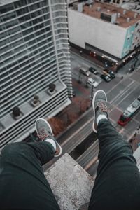 Low section of man sitting on terrace