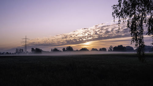 Scenic view of field against sky during sunset