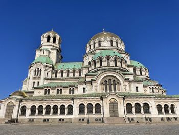 Low angle view of historic building against blue sky