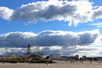 View of town square against cloudy sky