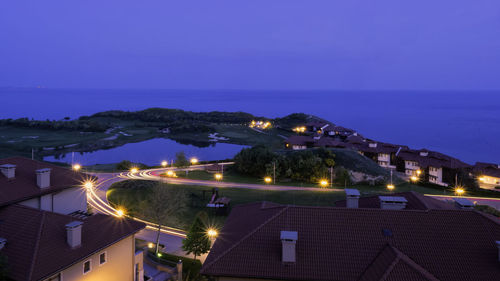 High angle view of illuminated buildings in city at night