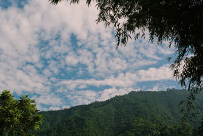 Scenic view of mountain against cloudy sky