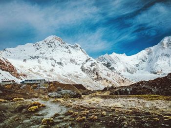 Scenic view of snowcapped mountains against blue sky