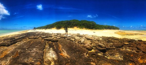 Scenic view of beach against blue sky