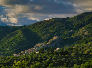 Scenic view of trees and mountains against sky