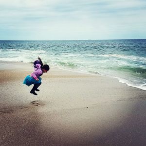 Girl playing on beach in usa