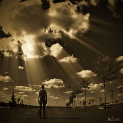 Silhouette of woman against cloudy sky