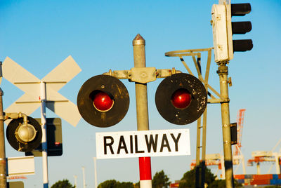 Low angle view of road signs against clear sky