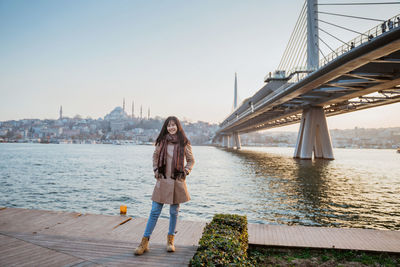 Rear view of woman walking on bridge