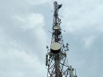 Low angle view of communications tower against sky