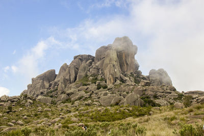 Low angle view of rock formations against sky