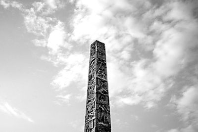 Low angle view of tower against cloudy sky