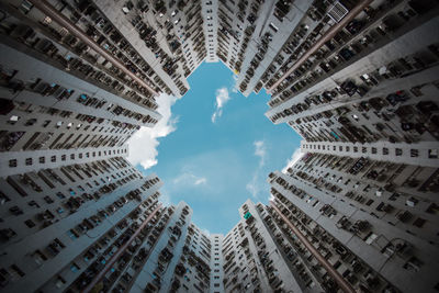 Low angle view of buildings against cloudy sky