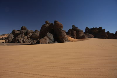 Scenic view of desert against clear sky acacus mountain, libya