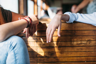 Cropped image of women sitting in train