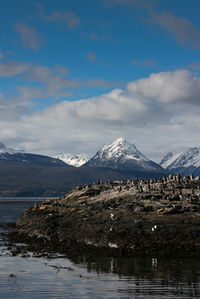 Scenic view of snowcapped mountains by lake against sky