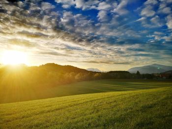 Scenic view of field against sky during sunset