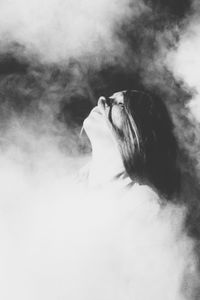 Woman standing amidst smoke