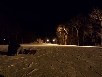 Road along trees at night