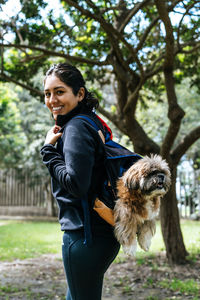 Portrait of smiling young woman with dog