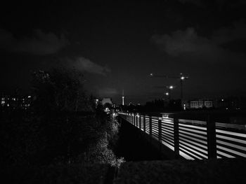 Illuminated city against sky at night