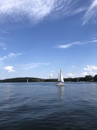 Sailboat sailing on sea against sky