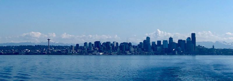 Panoramic view of sea and buildings against sky