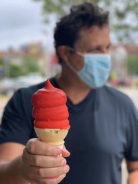 Midsection of woman holding ice cream outdoors