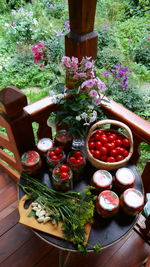 High angle view of garlic and dill on cutting board by jars on table