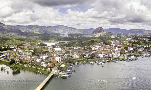 High angle view of townscape by river against sky