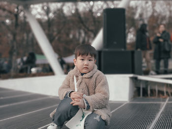 Portrait of cute boy looking away outdoors