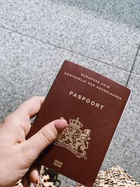 Cropped hand of woman holding passport