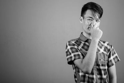 Portrait of young man against white background