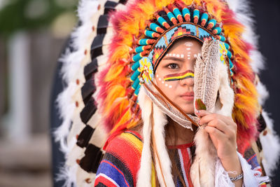 Portrait of woman with multi colored painting