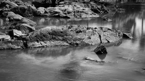 People in river amidst rock formation