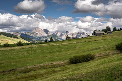 Scenic view of field and mountains against sky