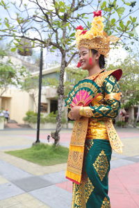 Young woman wearing costume standing outdoors