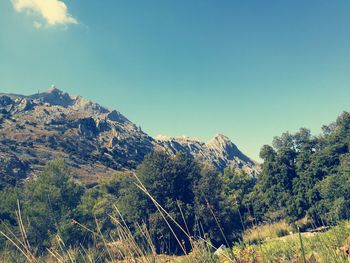 Scenic view of mountains against blue sky