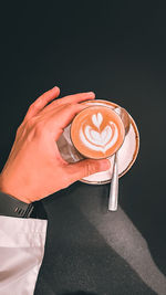 Close-up of hand holding coffee cup