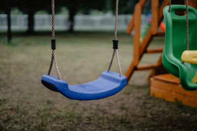 Close-up of empty swing in park