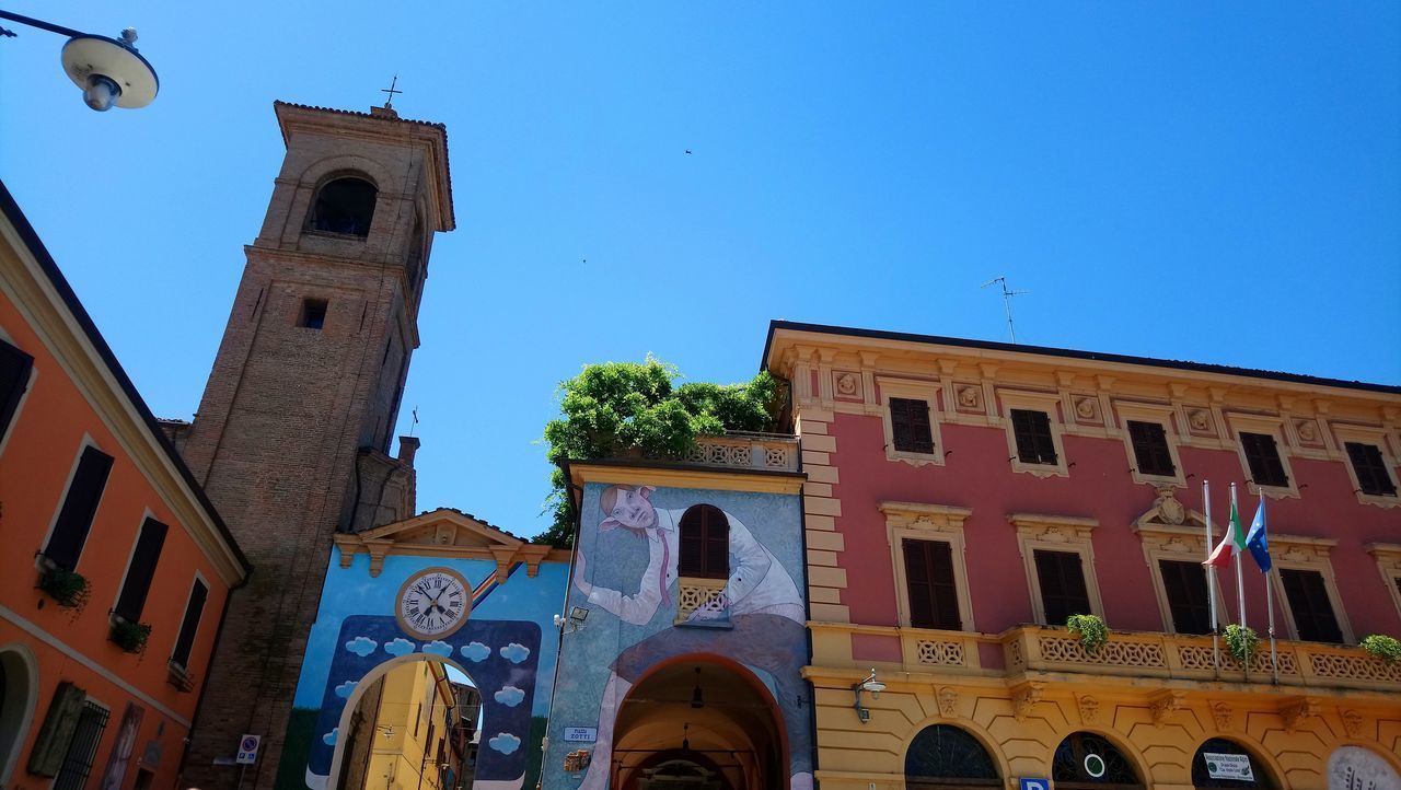 LOW ANGLE VIEW OF BUILDINGS AGAINST BLUE SKY