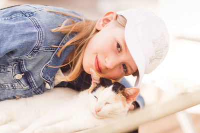 Portrait of girl with cat at home